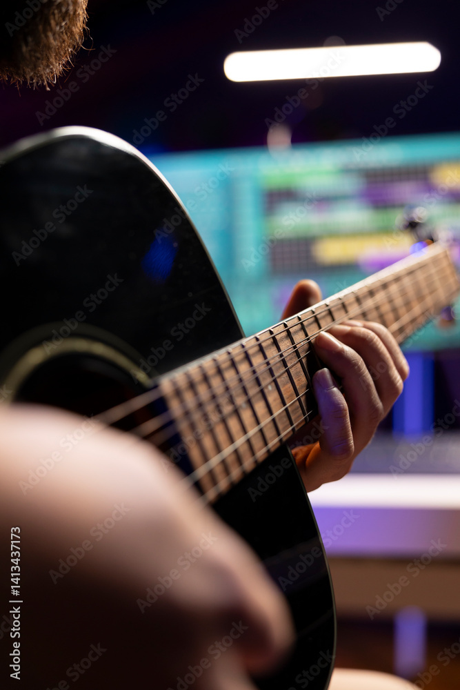 Poster skilled producer recording his song on guitar to mix and master music on daw software, working with 