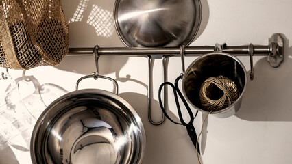 Kitchen utensils and tools displayed on a wall rack create an organized and functional cooking...