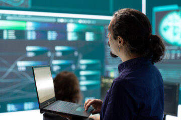 Cyber security team investigates governmental hacking malware attack on internet servers, high tech office. Cybercriminals hack computer systems, threatening account database protection.