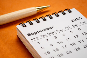 September 2025 - small spiral desktop calendar, time and business concept
