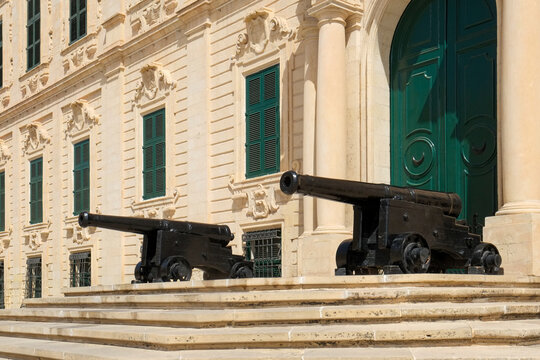Valetta, Malta. Government building with ancient canons lined up in front of the entry.