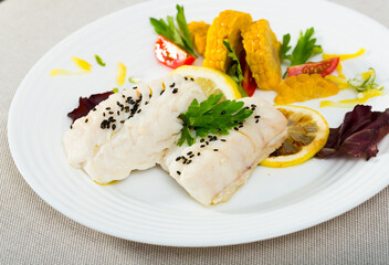 Cod of 250 grams prepared in frying pan in water with olive oil for 10 minutes. Add salt, pepper. Served with boiled corn, greens and lemon at plate