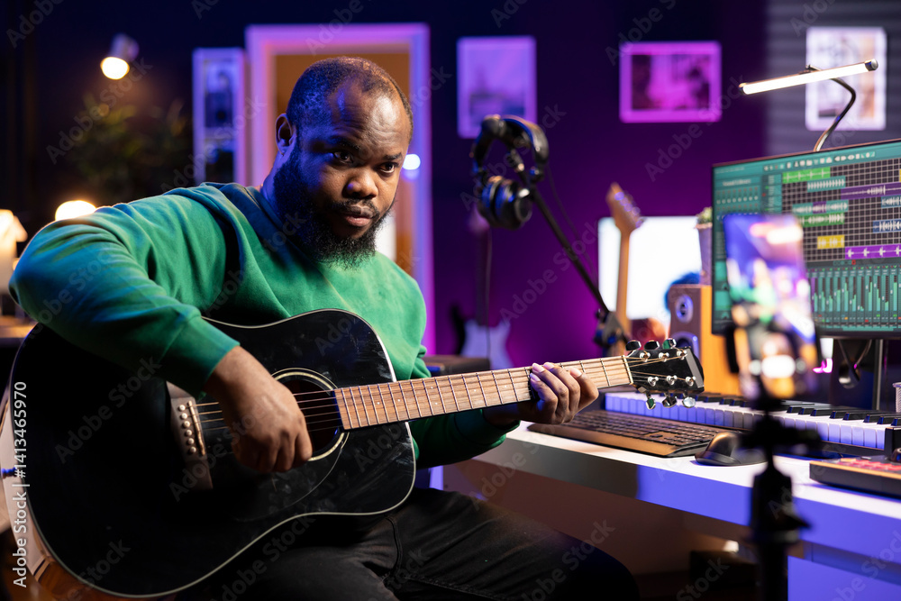 Fototapete professional composer teaching guitar lessons online on master class, recording himself playing acou