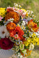 Kugelförmiger bunter Blumenstrauß in einer Vase