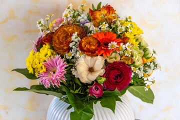 Kugelförmiger bunter Blumenstrauß in einer Vase