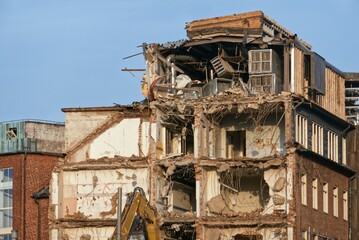 Short side of demolished building with several storeys.