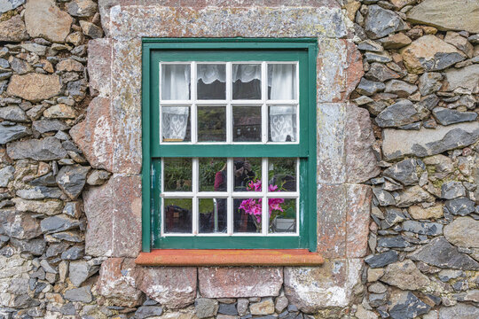 Aldeia da Cuada, Flores Island, Azores, Portugal. Paned window on a stone building.