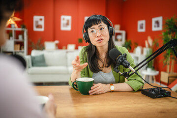 women in the podcast, focus on a japanese woman talk into a mic