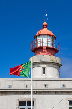 Ponta Delgada, Azores, Portugal. Portuguese flag and Albarnaz Lighthouse on Flores Island.