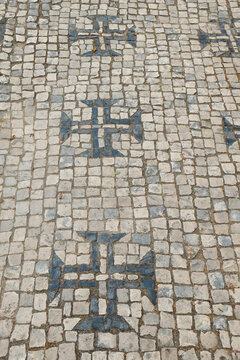 Tomar, Portugal. Traditional cobblestone sidewalk but with Templar crosses.
