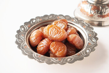 Traditional Turkish Candied Chestnuts designed in copper plate on white surface