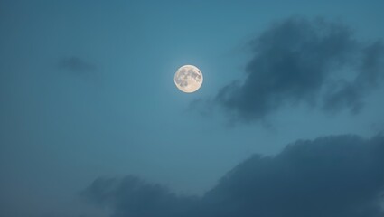 Daytime sky featuring a clear blue backdrop with a bright moon