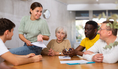 Group students different ages and multinational discussion during business course