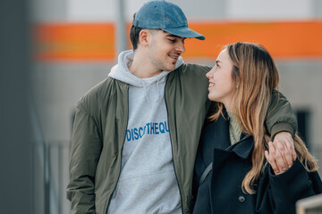 couple of boy and girl on the street outdoors hugging