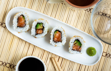 Appetizing sushi california roll with salmon and avocado
