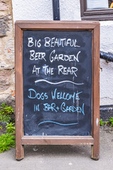 Fototapeta premium Lindisfarne, Holy Island, Berwick-upon-Tweed, Northumberland, England. Chalkboard sign outside pub.