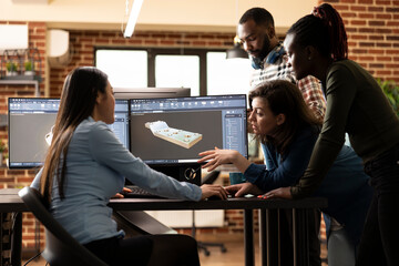 Multiethnic team of digital engineers collaborating with asian 3D artist to resolve a geometry challenge. Diverse experts working together at office desk, discussing and enhancing a virtual assets.