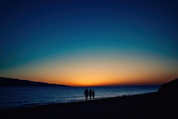A silhouette of a family walking on the beach at sunset, captured with a wide-angle lens and natural lighting The sky is painted in hues of orange and blue Generative AI