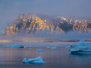 Midnight sun at Storoen Island. Uummannaq Fjord, northwest of Greenland beyond the arctic circle.