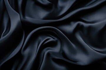 Obraz premium Dark navy blue satin fabric with soft, elegant folds and luxurious texture.