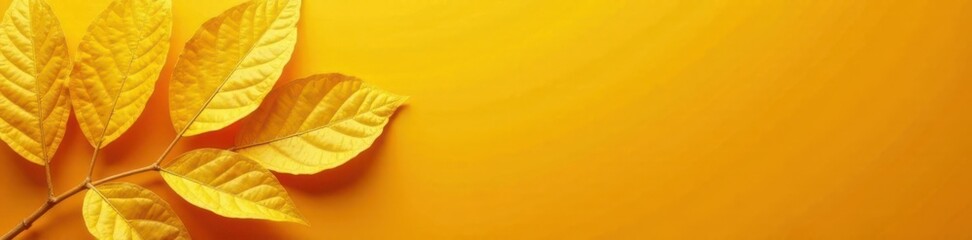 Obraz premium Sunny yellow leaf gold foil texture on a bright orange background, leaf, vibrant