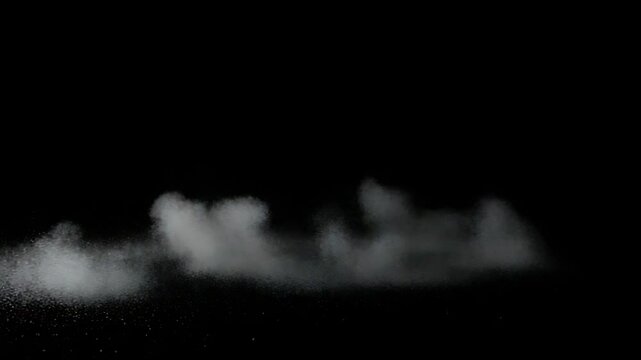 Small object impacting, creating a dust cloud on black background