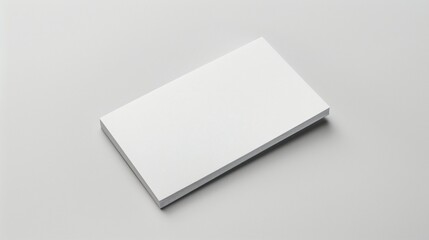 Blank white card on a flat surface, symbolizing simplicity and clarity in design.