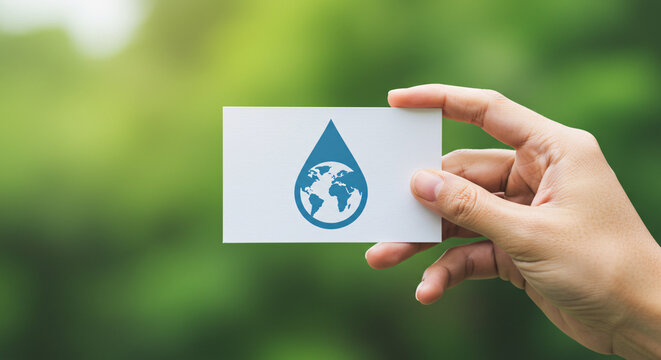 Hand Holding a Card with Earth and Water Drop Icon: A close-up shot of a hand holding a card with an icon depicting a water drop enveloping the Earth.