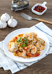 Fried shrimp with garlic and pepper on white plate - seafood style