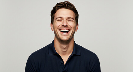 Obraz premium Man laughing with head tilted back, studio lights capturing natural joy and confidence.