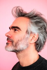 Obraz premium Visual idea of style for aging men. A strong and graceful male displaying confidence. Modish men's short caesar haircut - midlife white man with hair. Pink solid background.