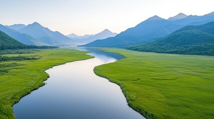 Serene river landscape tranquil meadow and hazy mountains