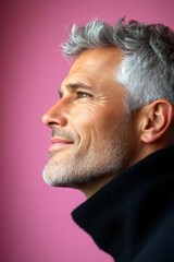 Fototapeta premium Pink solid background. Idea concept art of style for aging men. An expressive midlife man with a fashionable style. Trendy men's crew cut haircut - midlife white man with hair.