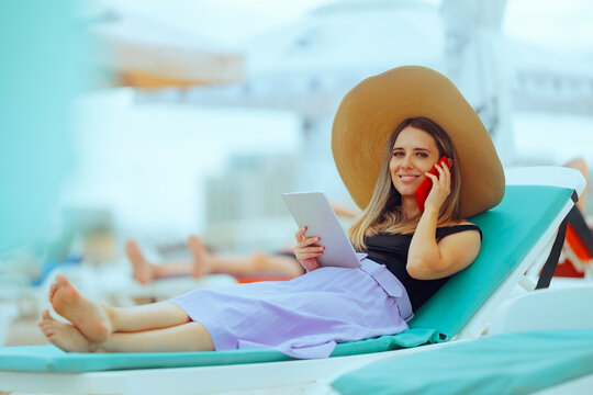 Woman at the Seaside on a Sunbed Working on Tablet and Phone. Person who works remotely on vacation because she is a workaholic