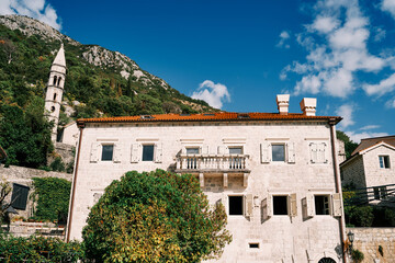Ancient stone mansion near the bell tower of the Church of Our Lady of the Rosary. Perast, Montenegro