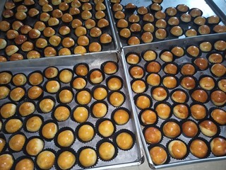 Golden brown nastar cookies cooling under warm kitchen light