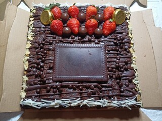 Chocolate brownies topped with fruits and space left for name