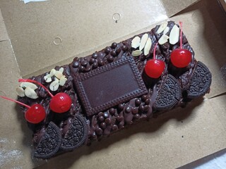 Chocolate brownies topped with fruits and space left for name