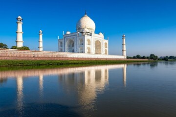 Obraz premium The Taj Mahal reflecting in the still waters of the Yamuna River during sunrise