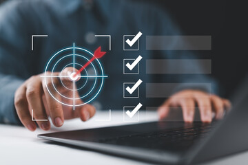 Business goal setting and task management. Businessman interacts with a digital checklist and...