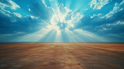 Obraz premium Open landscape with sunrays piercing through a partly cloudy, blue sky