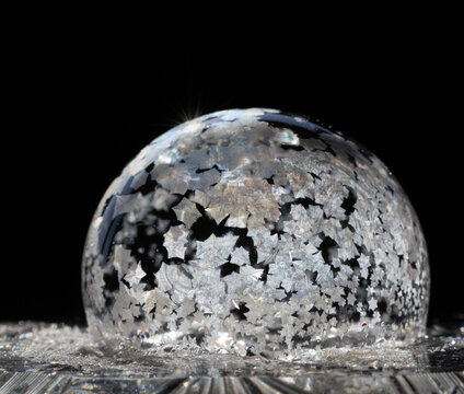 USA, Indiana, Carmel. Frozen soap bubble on a crystal glass base.