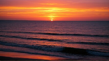 Obraz premium Fiery Horizon: A Spectacular Coastal Sunset Painting the Ocean with Vibrant Hues of Orange, Red, and Gold as Gentle Waves Kiss the Shoreline