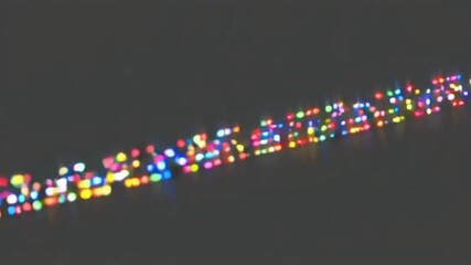 Against a black backdrop, a dazzling array of multicolored lights forms a string of illumination. Bright particles line up, producing glowing effects as they pulse rhythmically in the darkness - Powered by Adobe