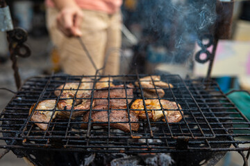 Meat pork grilled on fire outdoor camping party