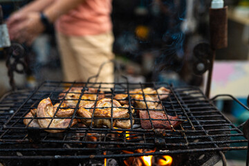 Meat pork grilled on fire outdoor camping party