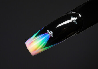 Black nail adorned with vibrant rainbow colors.