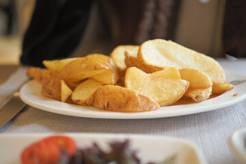 Crispy golden fried potatoes served on a white plate