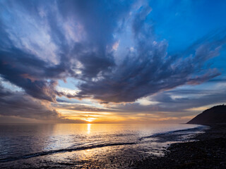 Sunset sky reflected on water on beach. Whidbey Island, Washington State.