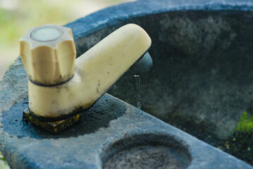Hand washing area made of natural stone, running water tap, sink in public park made of natural...